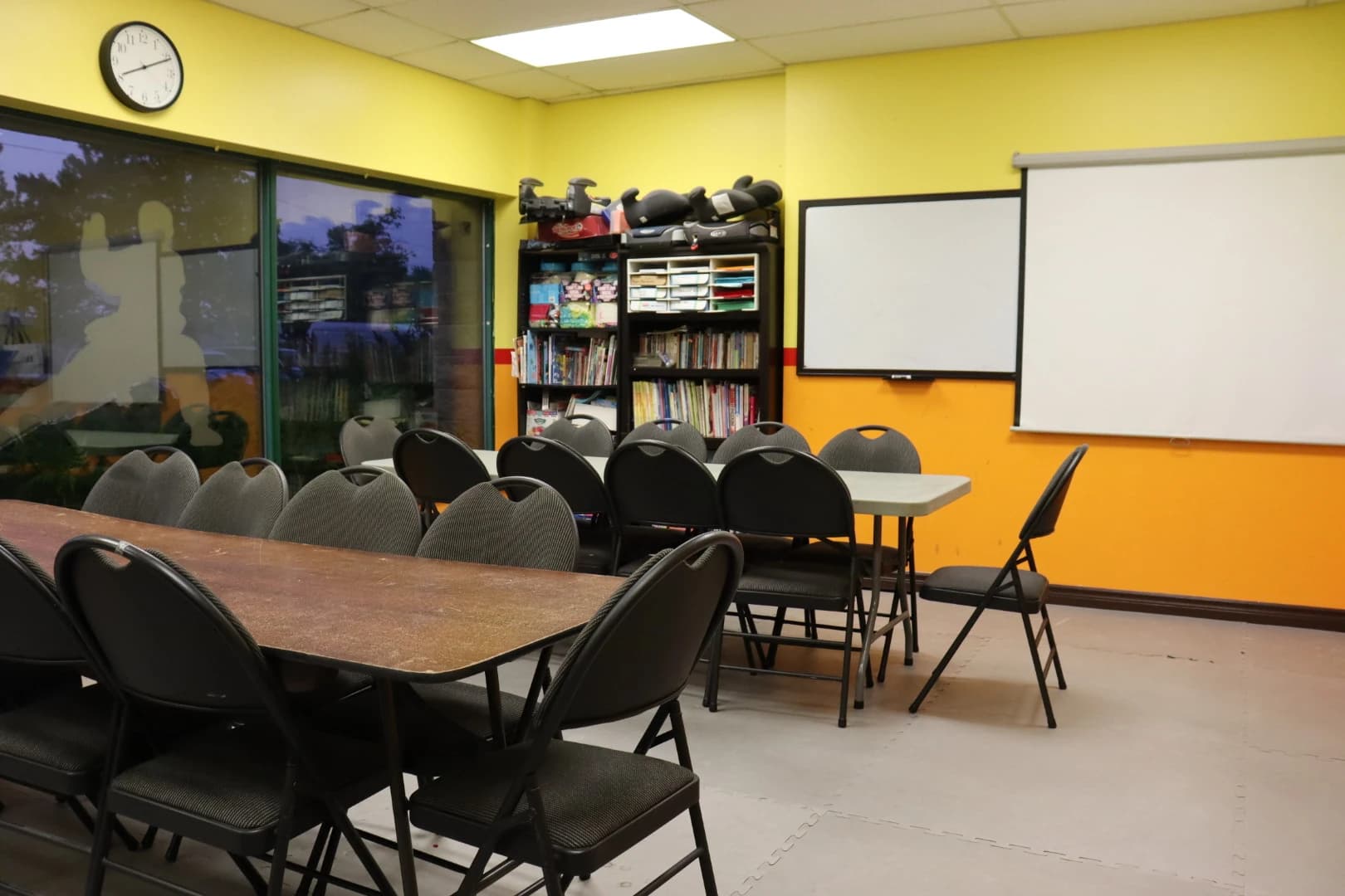 The dedicated classroom with tables and a whiteboard